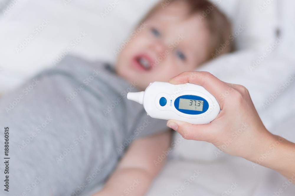 Reduce high fever. Medical thermometer showing high temperature in ice  cubes. Stock Photo