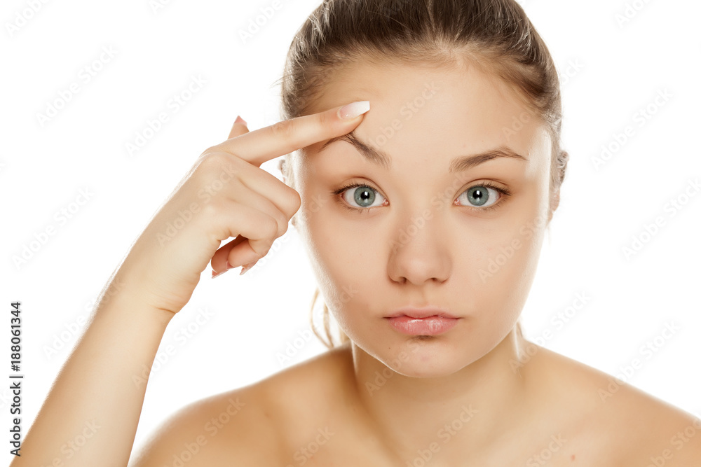 young girl lifted her eyebrow on white background young girl lifted her eyebrow on white background
