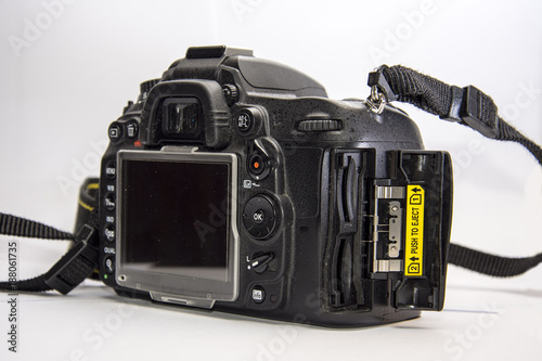 Mirror camera with open cover on memory cards.