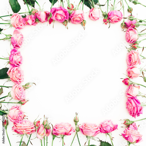 Fototapeta Naklejka Na Ścianę i Meble -  Floral frame of pink roses and buds on white background. Flat lay, Top view.