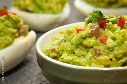 Healthy breakfast - eggs stuffed with guacamole with coriander and chili