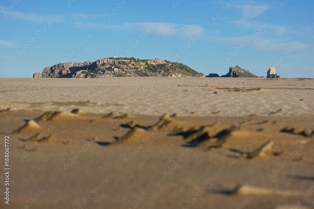 The Medes islands marine reserve at the horizon seen from a sandy ground on Estartit beach, Costa Brava, Catalonia, Spain, Mediterranean