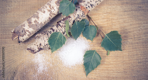 Xylitol - sugar substitute. Birch sugar on wooden background.