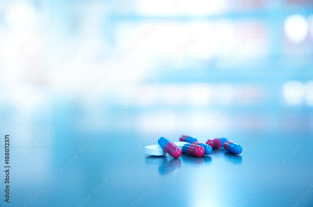 white pill and red blue capsule of medical drug light background Stock Photo | Stock
