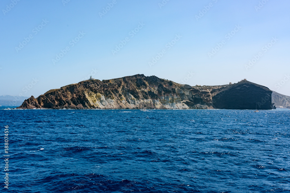 Rocky island with church. Santorini islands, Greece in summer.