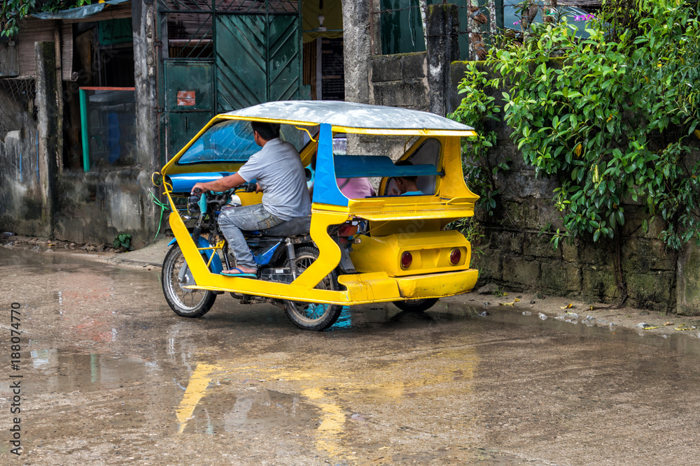 Obraz premium Tricycles on El Nido city centre after the rain, Philippines