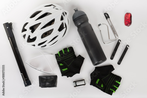 Bike accessories, bike helmet, bike gloves, eyeglasses and water bottle in holder photo