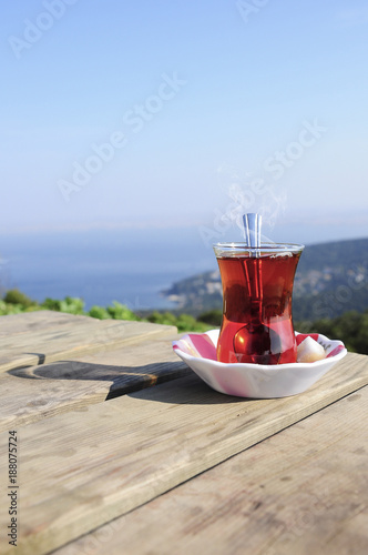 Canvas Print A glass of Turkish tea on a wooden table