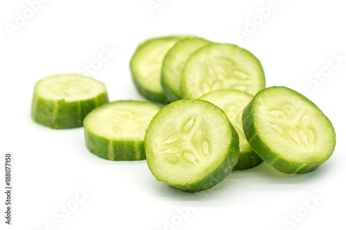 Closeup Slices of green cucumber isolated on white background .