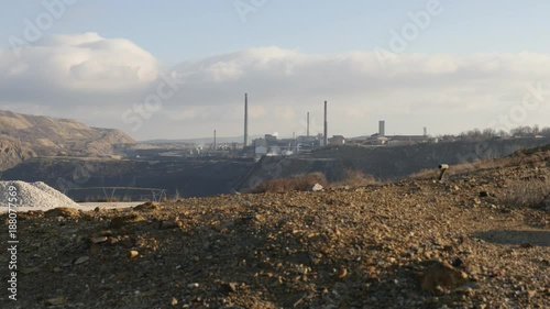 Tall industrial chimneys spreading smoke in the atmospere footage - Air and nature pollution with hot flue gases photo