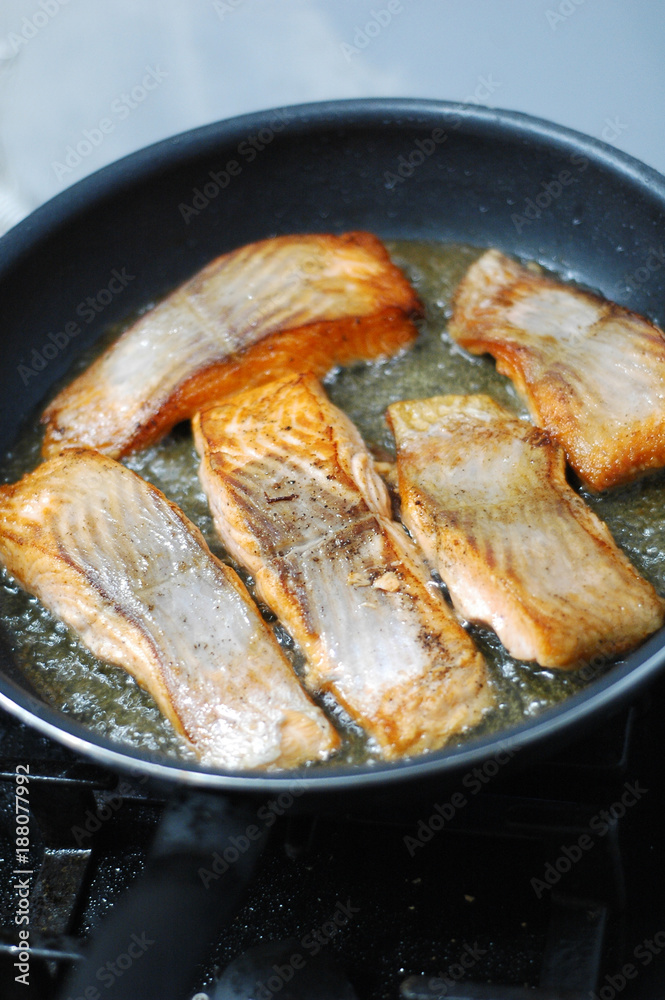 large steak of salmon is fried in sunflower oil. large steak of salmon is fried in sunflower oil.