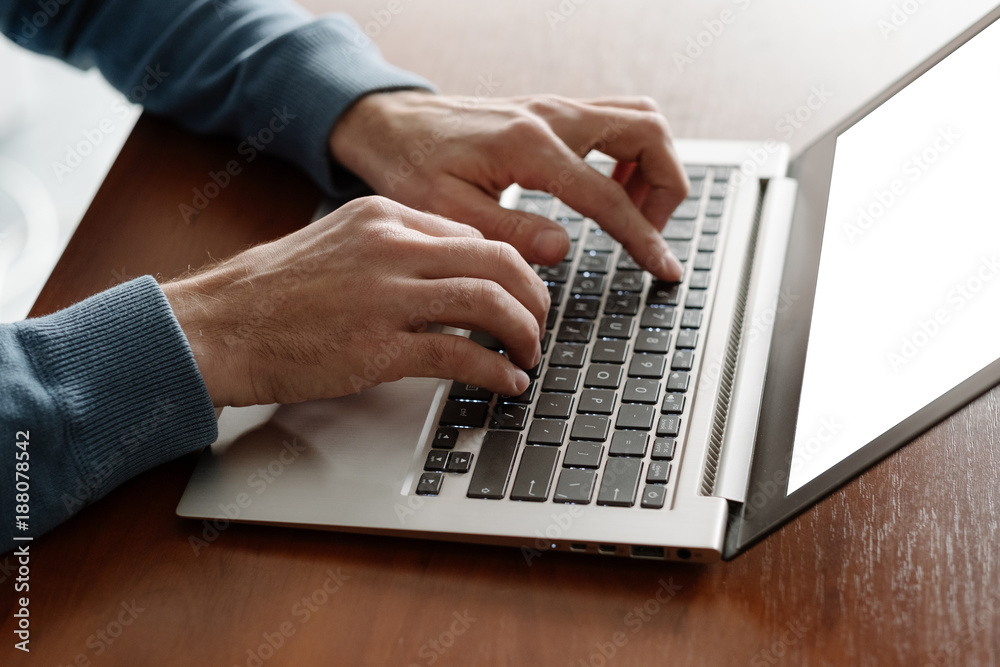Office work. Man typing on the laptop in office. White collar daily business routine Office work. Man typing on the laptop in office. White collar daily business routine
