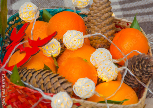 cones, oranges and garland in a Christmas basket