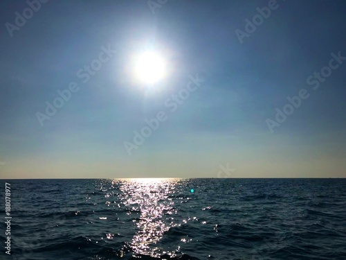 Beautiful silhouette of the afternoon sun with sky and blue sea, Koh Chang, Thialnad photo