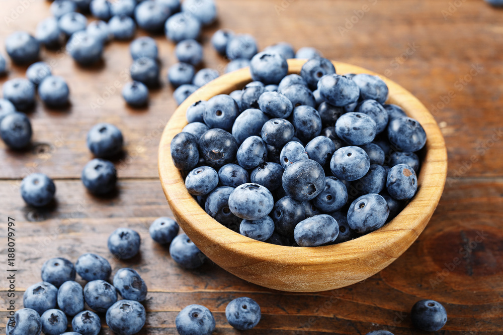 ripe organic bog whortleberry in a wooden plate on a wooden background ripe organic bog whortleberry in a wooden plate on a wooden background