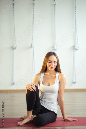 Attractive caucasian girl sitting on mat and wearing casual wear photo