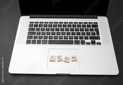 Virtual currency called icon written with letters on a modern laptop. Crypto currency concept image.