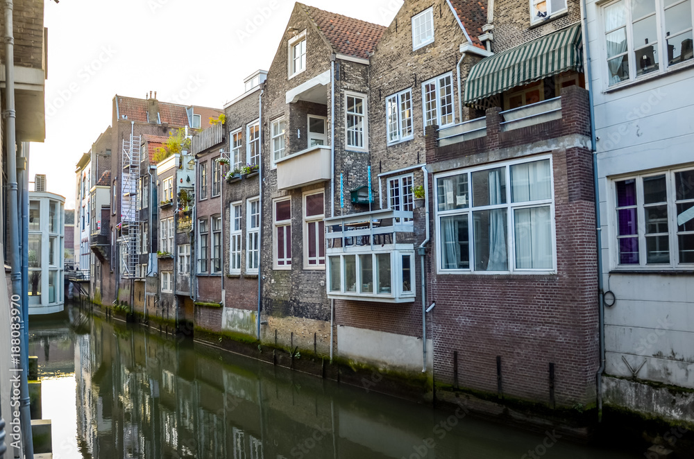 DORDRECHT, NETHERLANDS - OCTOBER, 17 2014: Facade of elegant brick buildings and street old town with houses at the canals Dordrecht Holland. South Netherlands.