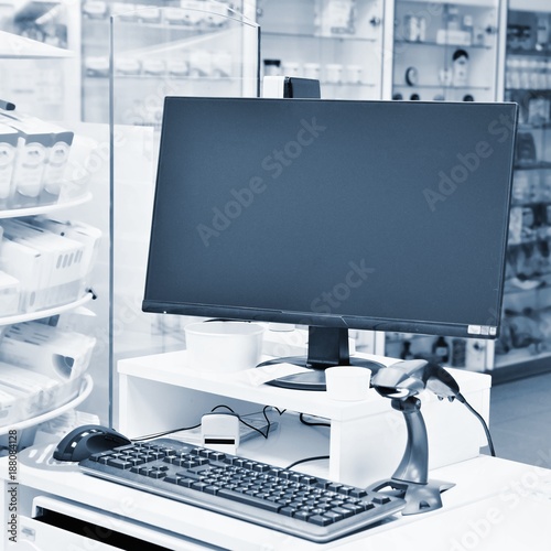 Cash desk - computer and monitor in a pharmacy. Interior of drug and vitamins shop. Medicines and vitamins for health and healthy lifestyle