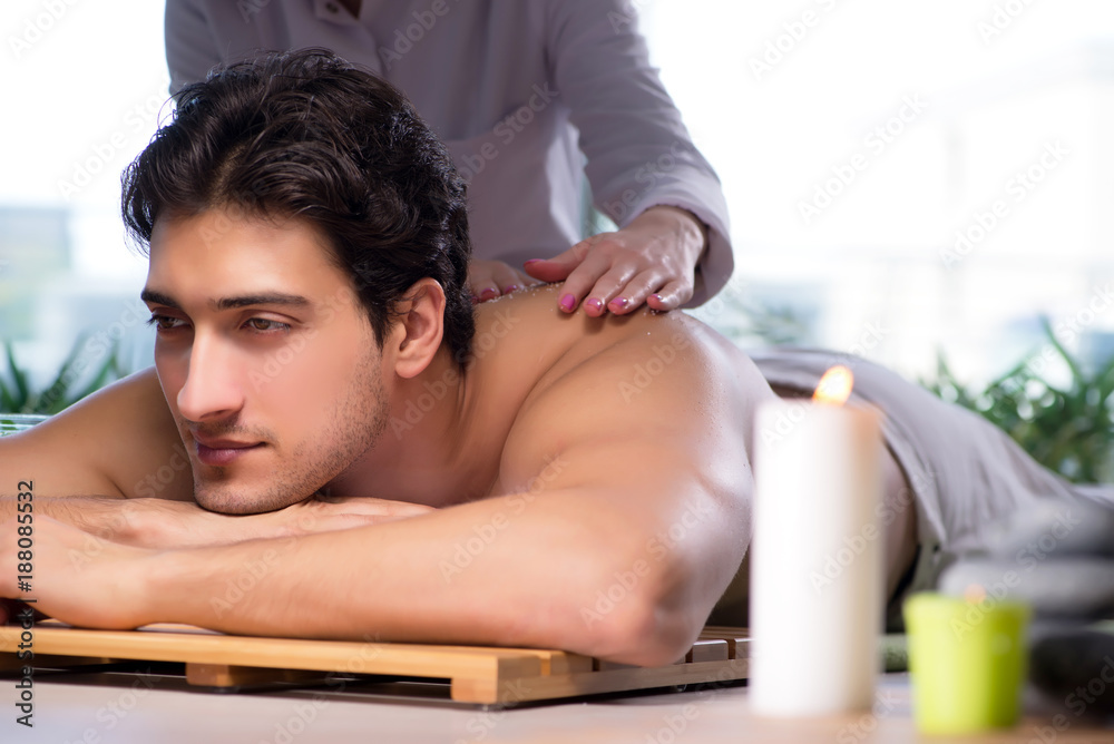Young handsome man during spa procedure Young handsome man during spa procedure