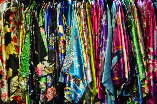 Colorful oriental clothes among the market stalls