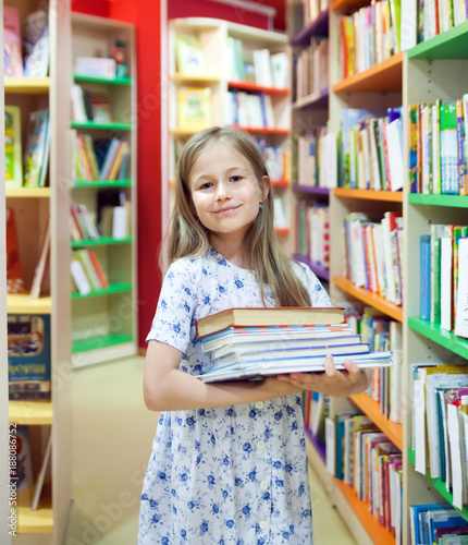  girl with books in library.