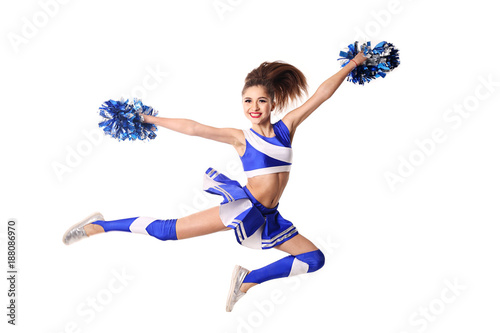 Young cheerleader in blue and white suit with pompoms on white background.