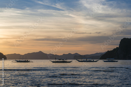 Bangka boats view at beautiful sunset on El Nido bay, Palawan island, Philippines