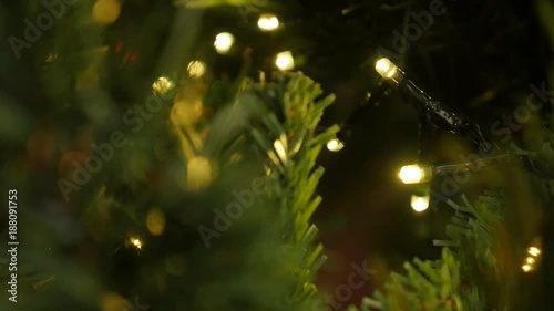 Shallow DOF Christmas warm color light blinks footage - Sparkling of fairy lights on the tree branches close-up