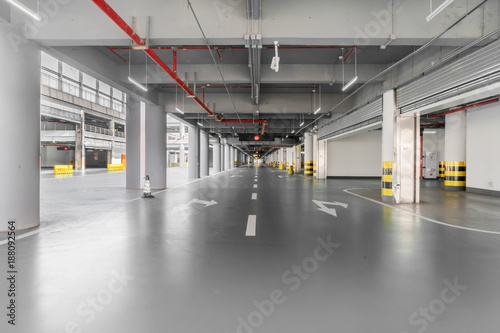 Fototapeta Naklejka Na Ścianę i Meble -  interior of parking garage with car and vacant parking lot in parking building
