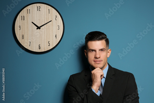 Handsome manager near wall ...