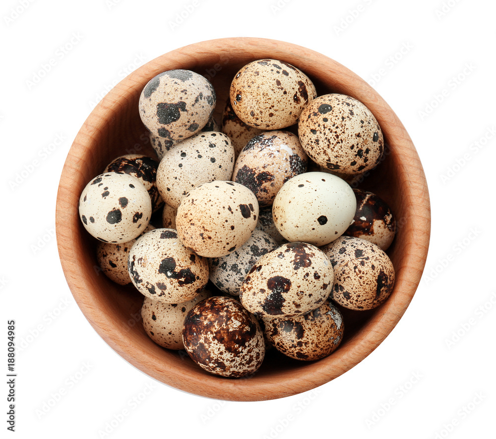 Quail eggs in bowl on white background