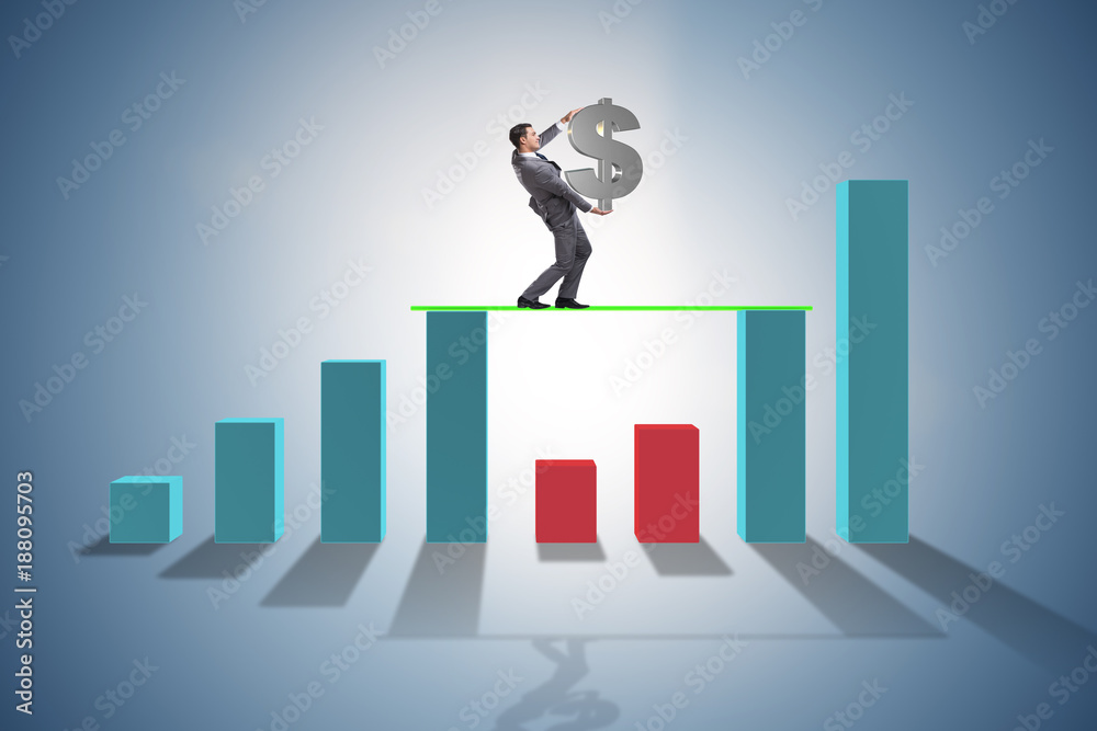 Young businessman in business concept with bar charts Young businessman in business concept with bar charts