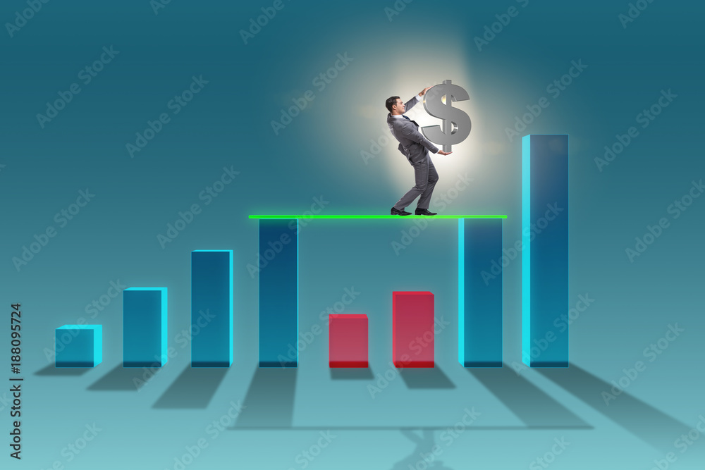 Young businessman in business concept with bar charts Young businessman in business concept with bar charts