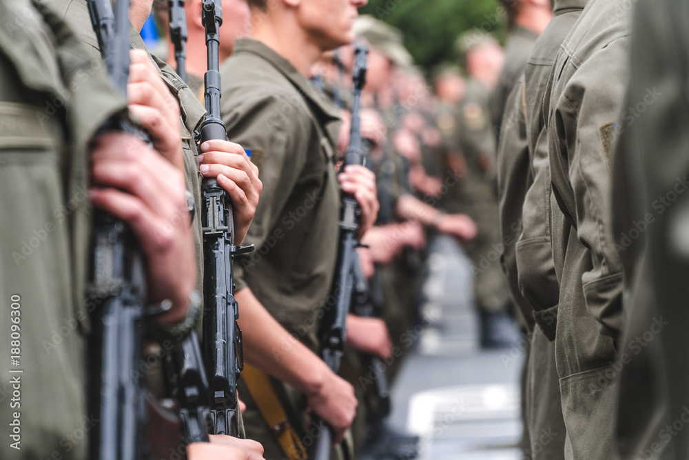 soldiers on construction with weapons in hands hold in hand the automatic machine on the street in clear day soldiers on construction with weapons in hands hold in hand the automatic machine on the street in clear day