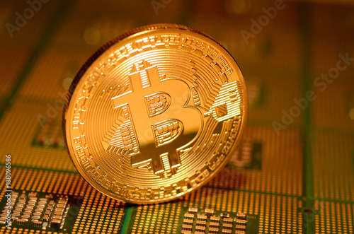 close up of phisical crypto currency bitcoin over computer cpu. background and business concept image. photo