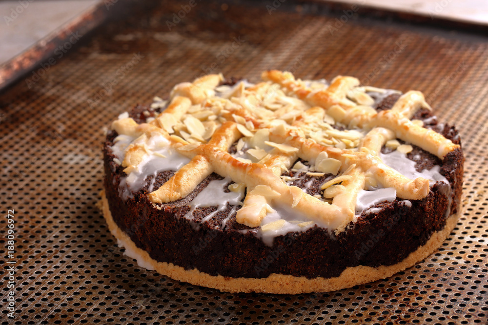 Easter poppy cake with almonds on baking sheet Easter poppy cake with almonds on baking sheet