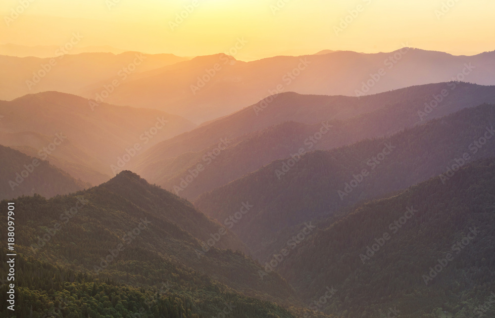 Mountain ridge during sunrise. Beautiful natural panoramic landscape in the summer time