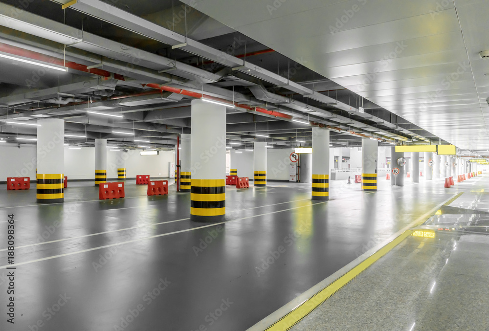interior of parking garage with car and vacant parking lot in parking building interior of parking garage with car and vacant parking lot in parking building