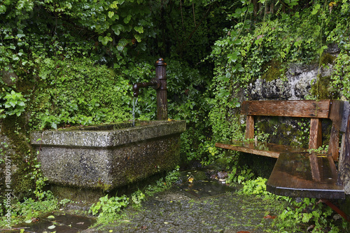 Stony fountain with mechanical water pump and bench in Hallstatt © Jiri Dolezal