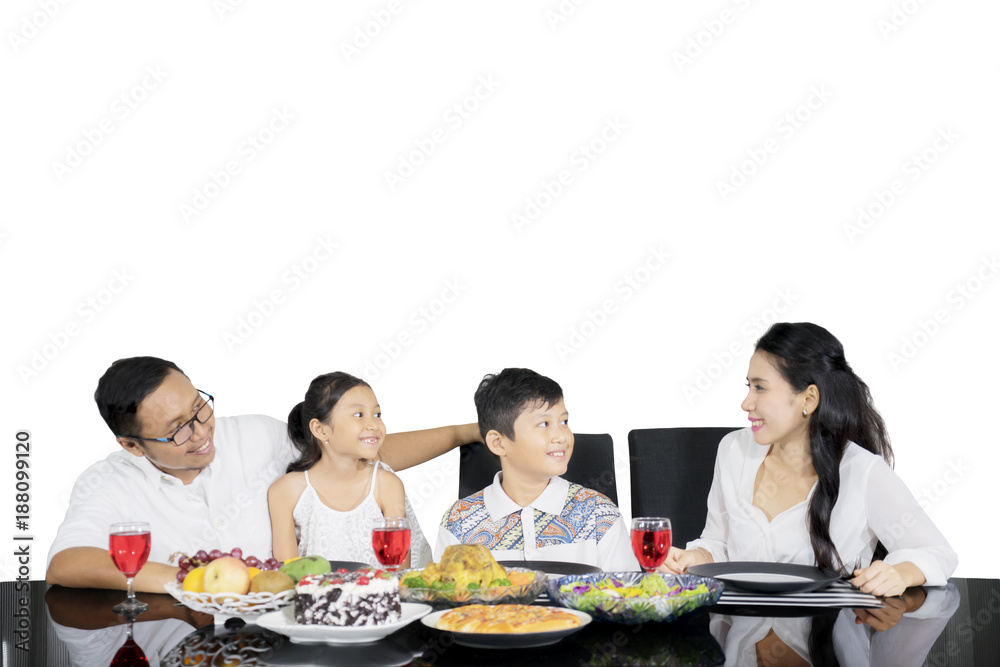 Young family enjoying lunch together on studio