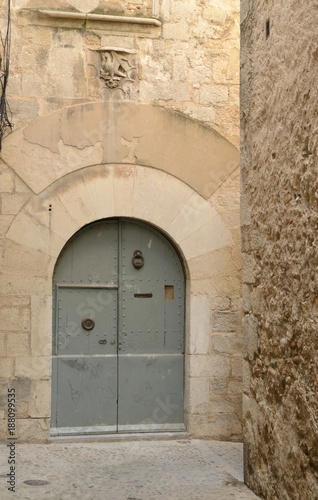 Old gate in cobblestone alley in Girona, Spain © monysasi