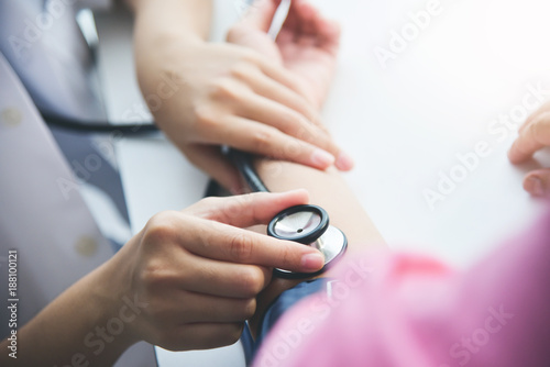 Female doctor measuring blood pressure. photo