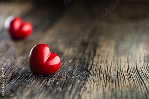 Valentines red heart. One two red heart on wooden table. Wedding or valentine...