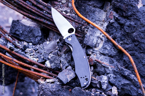 Knife among broken concrete and granite. photo