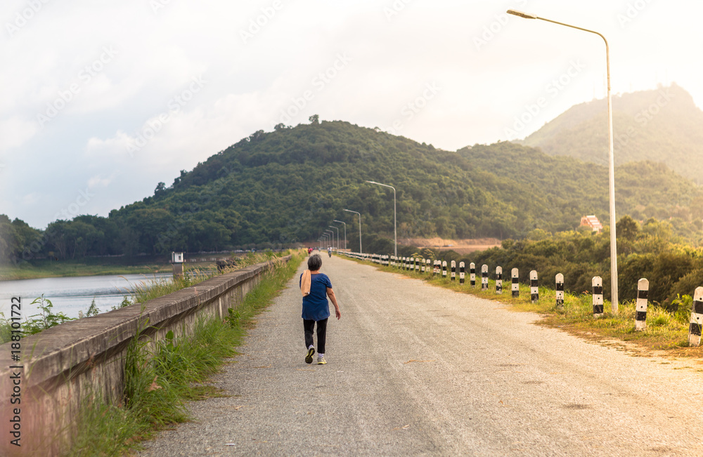 Fototapeta premium Back old female running in lakeside