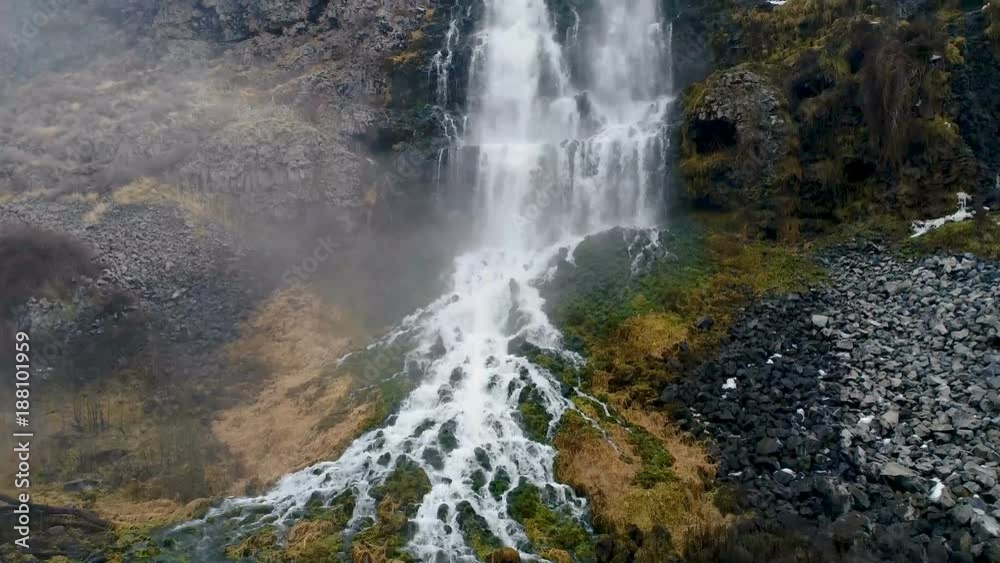 Moss and plants grow along the side of a large water fall in Idaho Moss and plants grow along the side of a large water fall in Idaho