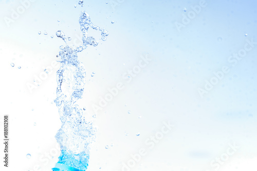 Bottle opening with water splashing isolated on white background.