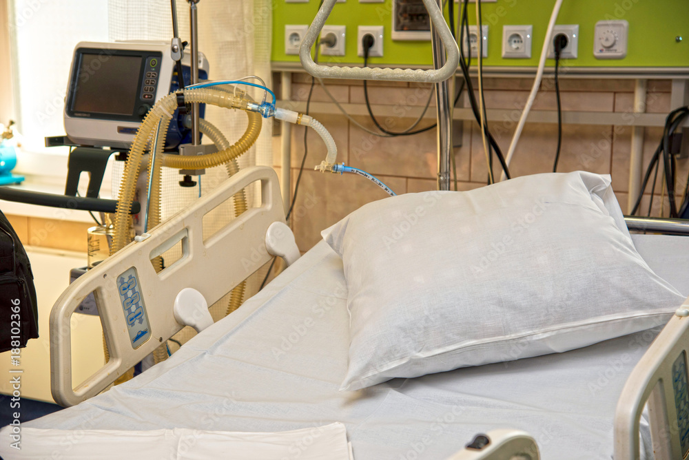 pillow on a modern medical bed and a special device in the modern ward of resuscitation in the hospital (patient recovery, death - concept)