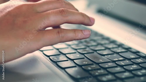 Close up hand worker typing on laptop keyboard 